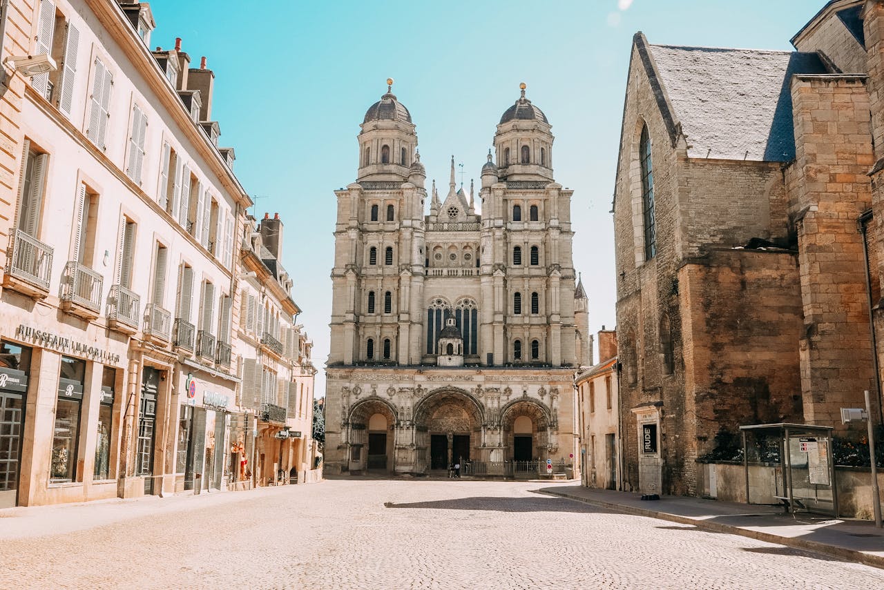 Crafting Captivating Headlines: Your awesome post title goes here Beautiful basilica and charming street in Dijon, France under a bright blue sky.